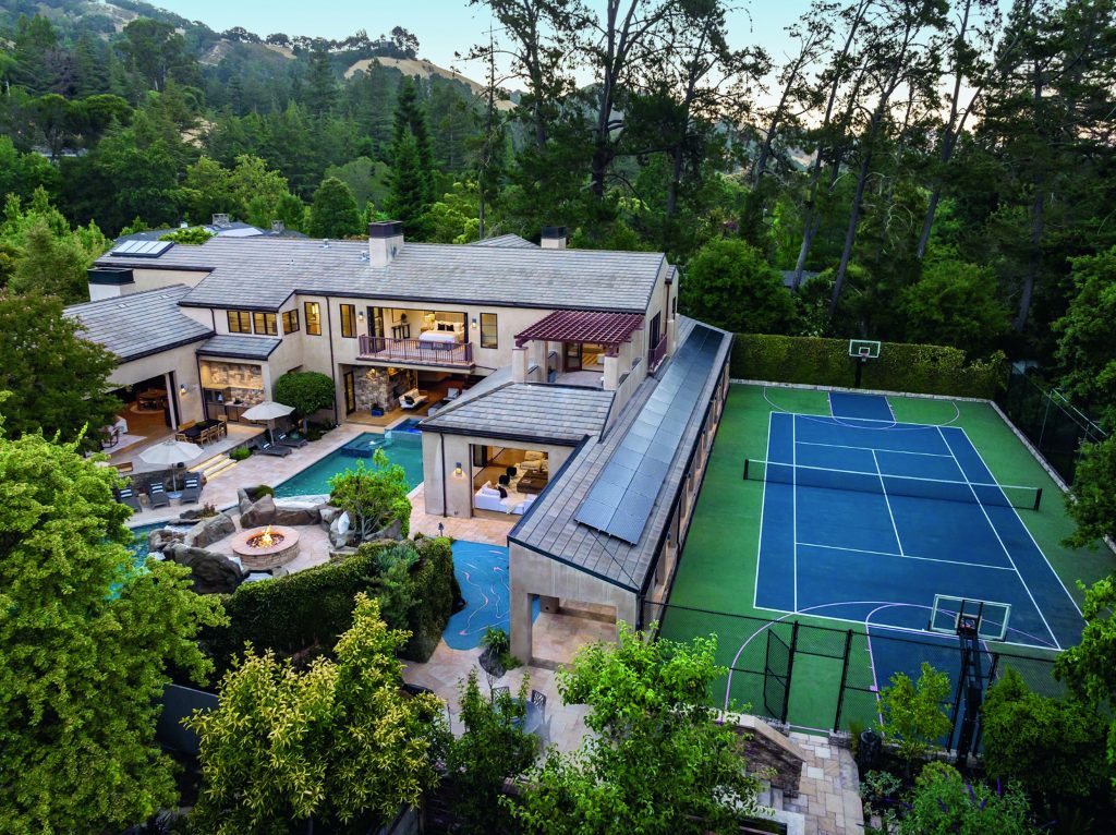 California estate with tennis court, basketball court, batting cage, and swimming pool with waterfalls and slide. There is also an on-site climbing wall, putting green, and bocce court.